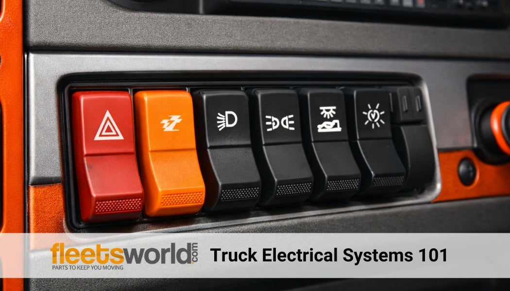 Close-up of semi truck dashboard switches, including hazard, auxiliary, and lighting controls, highlighting heavy-duty truck electrical system components with orange accent styling.